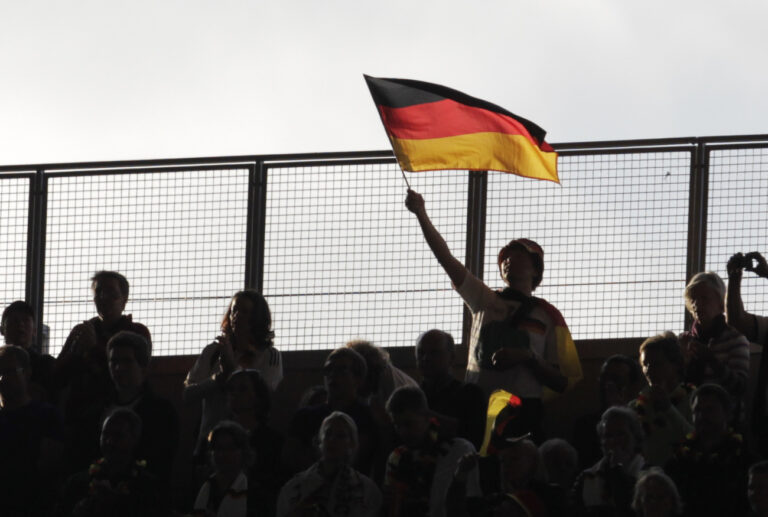 A fan waves a German flag during the group A match between Germany and Canada at the Women's Soccer World Cup in Berlin, Germany, Sunday, June 26, 2011. (AP Photo/Gero Breloer)
