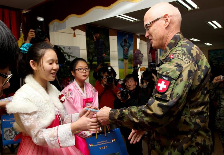 epa03584854 Swiss Urs Gerber (R) major general of the Neutral Nations Supervisory Commission (NNSC), greets graduate Oh Hyo-Jin (L) during a graduation ceremony for six students in Taesungdong Elementary School, which lies close to the heavily fortified demilitarized zone (DMZ) near Paju, South Korea, 15 February 2013. South Korea may impose new sanctions against North Korea for detonating its third nuclear device before the new South Korean government takes office on 25 February Yonhap news said on 15 February 2013. EPA/JEON HEON-KYUN / POOL