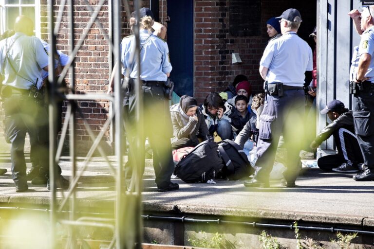 epa04922294 Refugees are being contained at Padborg Station by the Danish police after crossing the Danish - German border on 09 September 2015. Migrants, mainly from Syria and Iraq, arrived early morning at Padborg with a train from Germany and were placed at a school in Padborg from where they fled, to try to get to Sweden by walking the freeway. The police closed the freeway for security reasons. EPA/ALEX LUKA LADIME DENMARK OUT