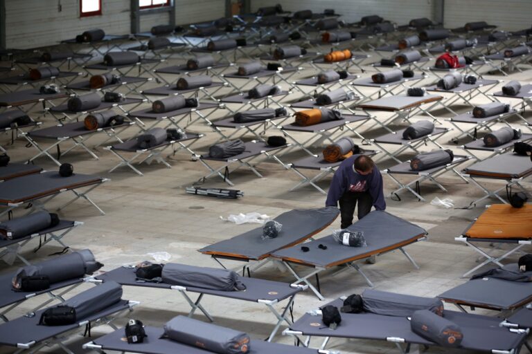 epa04936863 Helpers distribute camper beds and sleeping bags at a new reception centre for asylum seekers in Geutensweg, Hamburg 18 September 2015. On Friday around 300 beds were provided in the building which could house up to 500 refugees. A total of 4,200 refugees are expected to be housed in the district Neugraben-Fischbek of the city. P EPA/CHRISTIA CHARISIUS