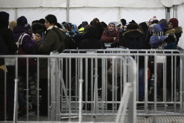 Migrants and refugees wait inside a separate tent for woman and children at the central registration center for refugees and asylum seekers LaGeSo (Landesamt fuer Gesundheit und Soziales - State Office for Health and Social Affairs) LaGeSo in Berlin, Germany, Monday, Jan. 4, 2016. (AP Photo/Markus Schreiber)