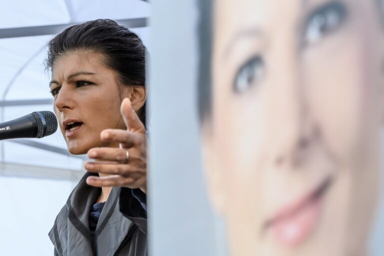 epa06215537 Parliamentary group leader of the left-wing party 'Die Linke' and top candidate for the upcoming general elections, Sahra Wagenknecht, speaks next to a campaign poster, during a campaigning event in the Berlin district of Lichtenberg in Berlin, Germany, 20 September 2017. Some hundreds of people attended her speech, where she criticized the political course of German Chancellor Angela Merkel and posed for selfies with her supporters. EPA/CLEMENS BILAN