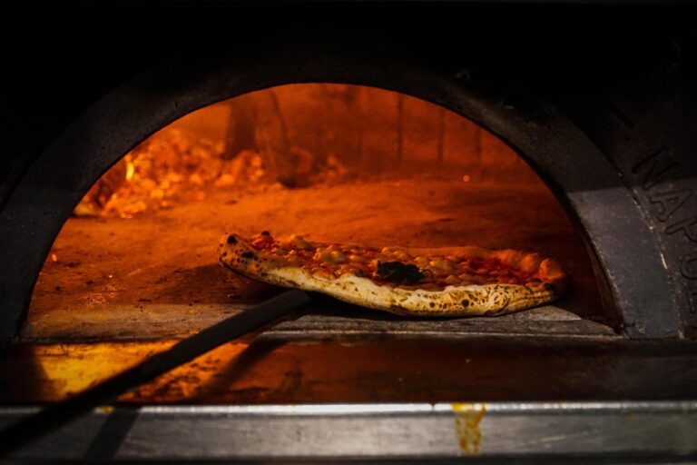 epa06373776 A Neapolitan 'Pizzaiuolo' (pizza maker) bakes a pizza in Naples, southern Italy, 07 December 2017. UNESCO said that the art of the Neapolitan 'Pizzaiuolo' (pizza maker) has been put on its Intangible Cultural Heritage list. EPA/CESARE ABBATE