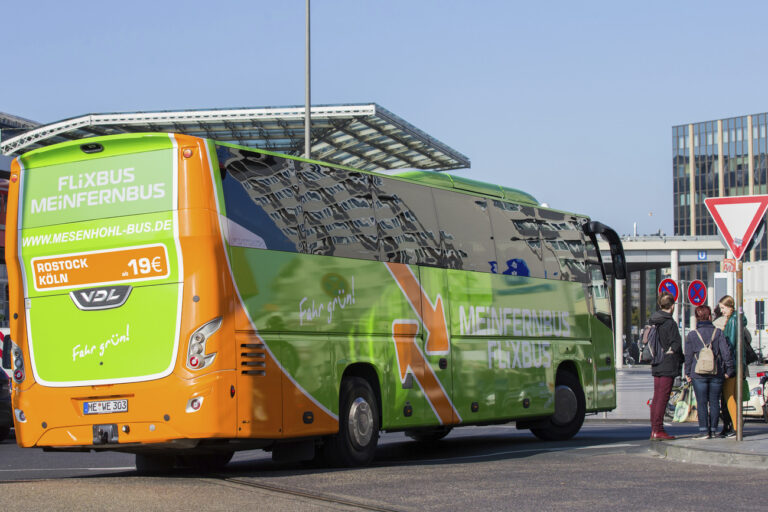 FILE - In this Oct. 27, 2015 file photo a FlixBus bus leaves the bus terminal in Cologne, western Germany. European coach service startup FlixBus says it plans to expand into the U.S. market in the coming months, where it will compete with established operators such as Greyhound Lines and Megabus. (Rolf Vennenbernd/dpa via AP)