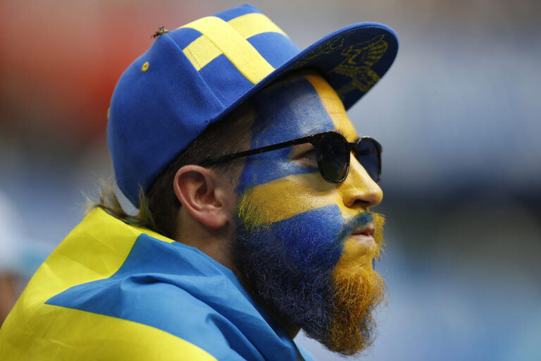 Sweden's supporter face painted in Sweden's national flag awaits the start of the quarterfinal match between Sweden and England at the 2018 soccer World Cup in the Samara Arena, in Samara, Russia, Saturday, July 7, 2018. (AP Photo/Francisco Seco)