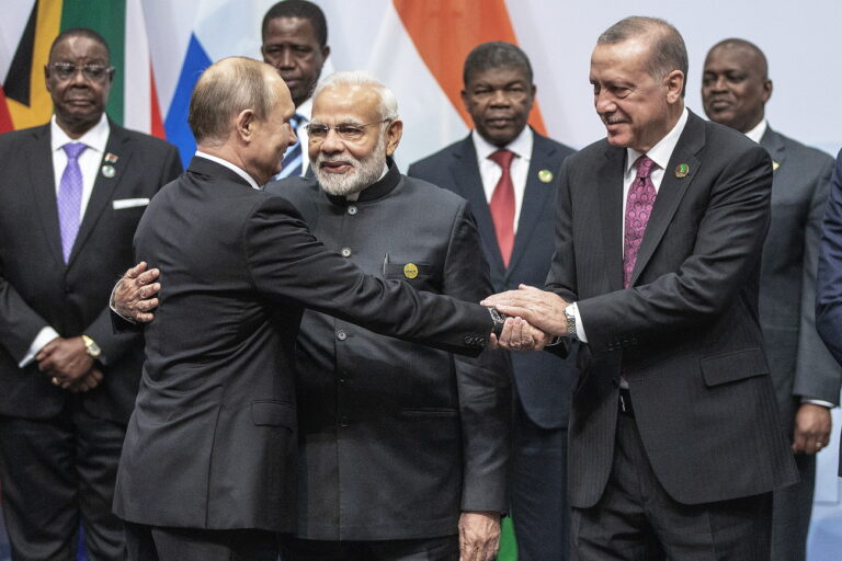 epa06913710 Russian President Vladimir Putin (L) Indian Prime Minister Narendra Modi (C) and Turkish President Recep Erdogan (R) interact during a family photo during the BRICS summit meeting in Johannesburg, South Africa, 27 July 2018. The summit is held over three days and ends on 27 July. EPA/GIANLUIGI GUERCIA / POOL