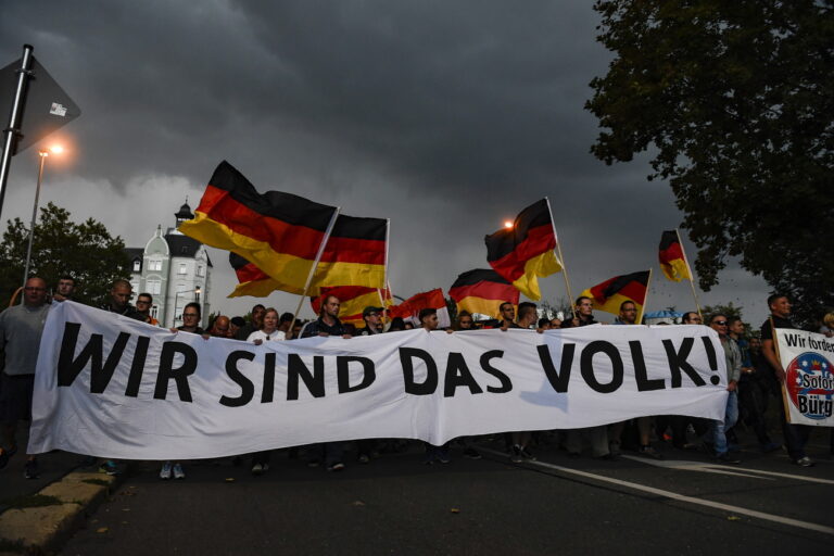 epa07003732 Protesters display a banner reading 'Wir sind das Volk!' (We are the people!) during a rally of right-wing populist movement 'pro Chemnitz' in central Chemnitz, Germany, 07 September 2018. A 35-year-old man reportedly was stabbed and died shortly after what police described as a 'scuffle between members of different nationalities' at a city festival. The incident kept police and the city government busy since then as there were several spontaneous marches of hundreds of right-wing supporters in Chemnitz. EPA/FRANZ FISCHER