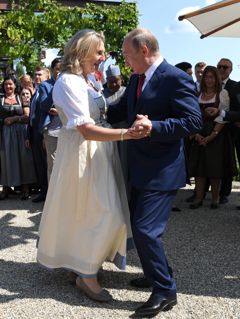 In this Saturday, Aug. 18, 2018 photo Russian President Vladimir Putin, right, dances with Austrian Foreign Minister Karin Kneissl as he attends the wedding of Kneissl with Austrian businessman Wolfgang Meilinger in Gamlitz, southern Austria. (Roland Schlager/Pool photo via AP)