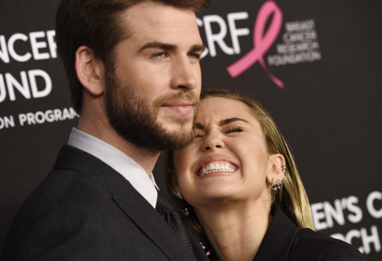 Singer Miley Cyrus, right, mugs alongside husband Liam Hemsworth at the 2019 