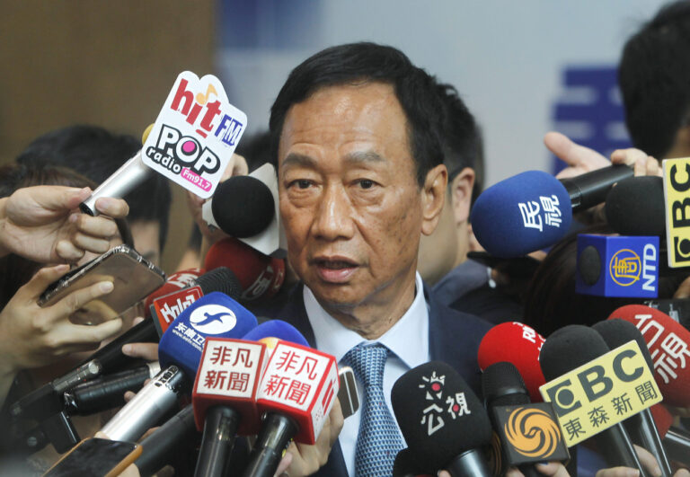 Terry Gou, the head of the world's largest electronics supplier Foxconn, is surrounded by the media after meeting with Nationalist Party chairman Wu Den-yih at the party headquarters in Taipei, Taiwan, Monday, May 13, 2019. Gou plans to run for president of Taiwan, bringing his pro-business and pro-China policies to what is expected to be a crowded field for next year's election. (AP Photo/Chiang Ying-ying)