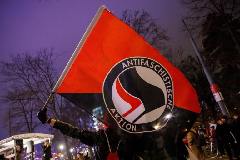 epa08160642 A protester waves a antifa flag during a demonstration against Austrian Freedom Party's (FPOe) 'Akademikerball' (Academics Ball) in Vienna, Austria, 24 January 2020. About 1200 people took part in the demonstration and police deployed about 1,600 officers to protect the ball's 2,500 visitors in the Hofburg Palace. EPA/FLORIAN WIESER