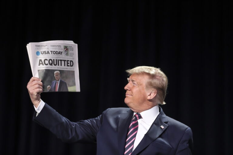 epa08197934 US President Donald J. Trump holds a copy of the USA Today newspaper fronting with his Impeachment acquittal, as he arrives to the 68th Annual National Prayer Breakfast in Washington, DC, USA, 06 February 2020. The Senate on 05 February 2020 acquitted US President Trump in the impeachment trial on the charges of abuse of power and obstruction of Congress. EPA/Oliver Contreras / POOL