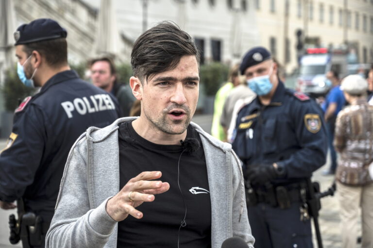 epa08382398 Martin Sellner, leader of the far right Identitarian Movement Austria (Identitaere Bewegung Oesterreich), speaks to journalists during a demonstration against the measures of the Austrian government to slow down the ongoing pandemic of the COVID-19 disease caused by the SARS-CoV-2 coronavirus in Vienna, Austria, 24 April 2020. EPA/CHRISTIAN BRUNA