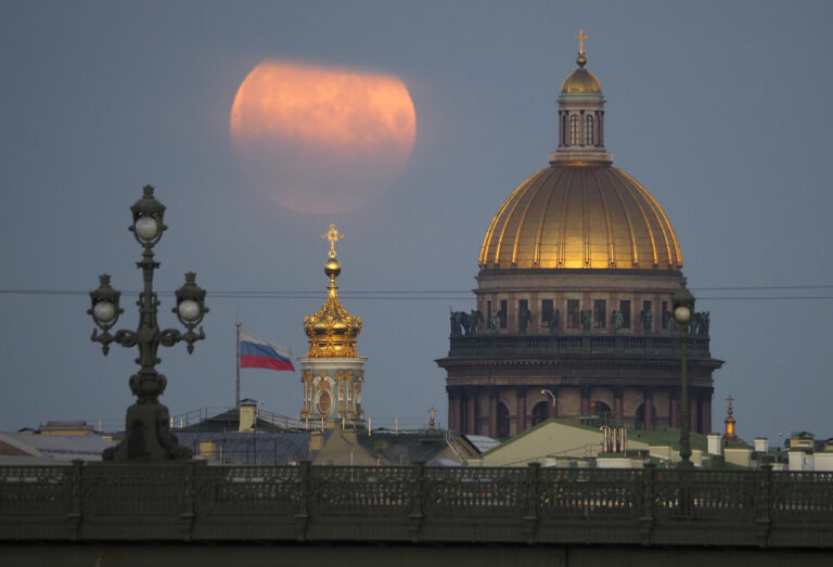 The full moon sets in the clouds over the St. Isaac's Cathedral in St. Petersburg, Russia, Saturday, June 6, 2020. (AP Photo/Dmitri Lovetsky)