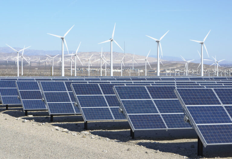 Solar panels and wind turbines. Photovoltaic solar panels and wind turbines, San Gorgonio Pass Wind Farm, Palm Springs, California, USA. This solar installation has a 2.3 MW capacity. (KEYSTONE/SCIENCE SOURCE/GIPhotoStock)
