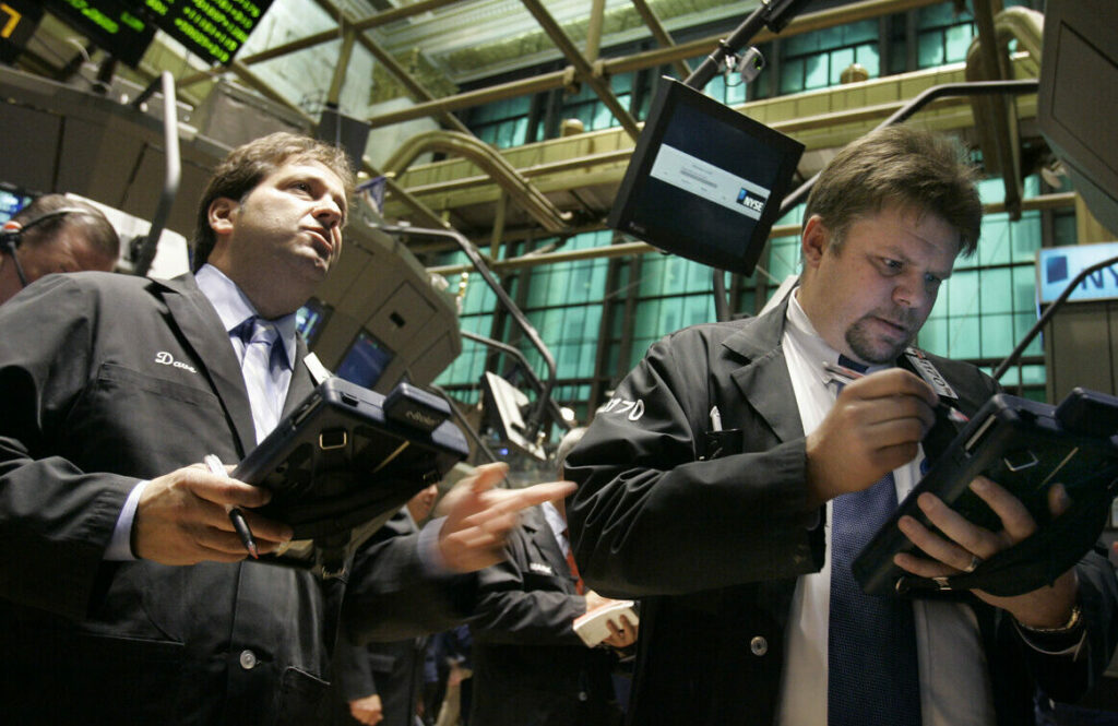 Traders work on the floor of the New York Stock Exchange, Wednesday, Sept. 19, 2007. Stocks bounded higher and bonds fell Wednesday as Wall Street extended its rally a day after a half-point rate cut from the Federal Reserve. A mild reading on consumer prices added to the market's momentum. The Dow Jones industrials at times rose more than 100 points. (AP Photo/Richard Drew)