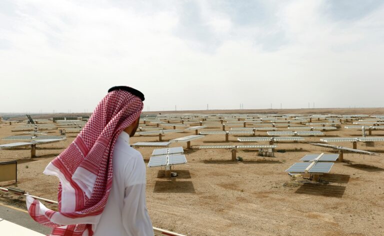 Saudi man looks at the solar plant in Uyayna, north of Riyadh