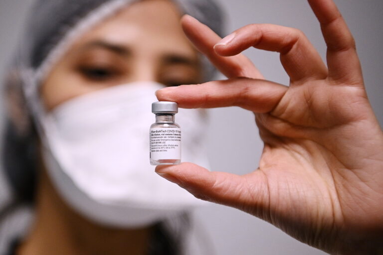 epa08922733 A health worker holds a vial containing the Pfizer-BioNTech COVID-19 vaccine in Aulnay-sous-Bois, France, 06 January 2021, as several French medical representatives and personalities receive the vaccine. France began its coronavirus disease (COVID-19) vaccination campaign on 27 December 2020. The French government has faced criticism over the slow progress of its drive to vaccinate people, a problem compounded by the high levels of public skepticism about the campaign. EPA/CHRISTOPHE ARCHAMBAULT / POOL MAXPPP OUT