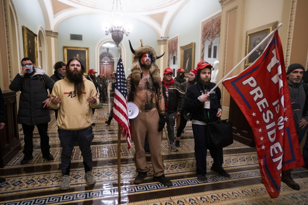 epa08923457 Supporters of US President Donald J. Trump stand by the door to the Senate chambers after they breached the US Capitol security in Washington, DC, USA, 06 January 2021. Protesters stormed the US Capitol where the Electoral College vote certification for President-elect Joe Biden took place. EPA/JIM LO SCALZO