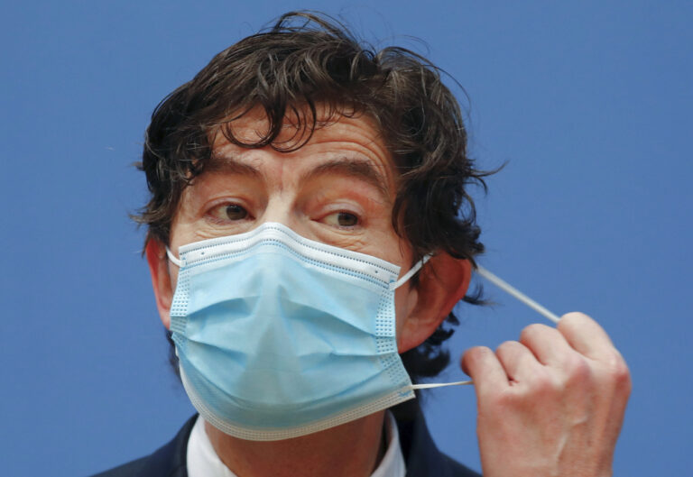 Director of the Institute for Virology at the Charite Christian Drosten adjusts his face mask during a news conference, amid the spread of the coronavirus disease (COVID-19), in Berlin, Germany, Friday, Jan. 22, 2021. (Fabrizio Bensch/Pool via AP)