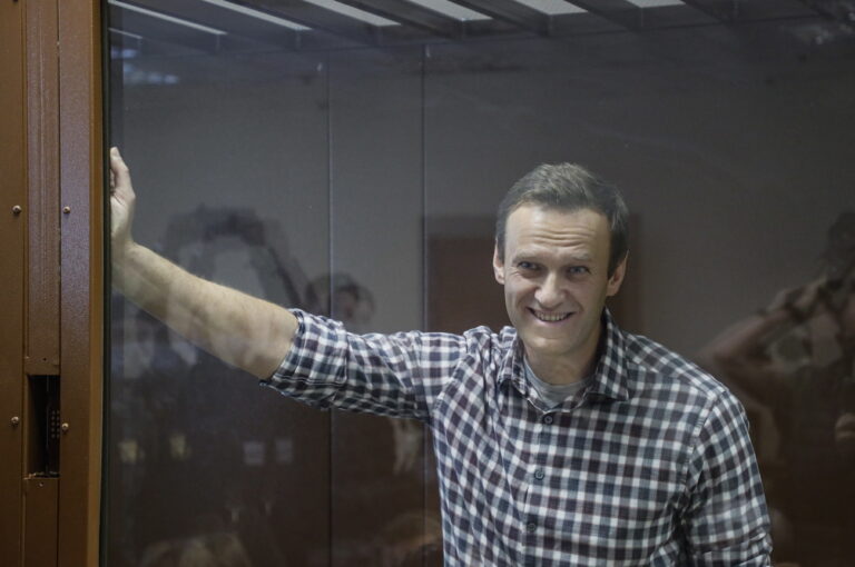 epa09025236 Russian opposition leader Alexei Navalny stands inside a glass cage prior to a hearing at the Babushkinsky District Court in Moscow, Russia, 20 February 2021. The Moscow City court will hold a visiting session at the Babushkinsky District Court Building to consider Navalny's lawyers appeal against a court verdict issued on 02 February 2021, to replace the suspended sentence issued to Navalny in the Yves Rocher embezzlement case with an actual term in a penal colony. EPA/YURI KOCHETKOV MANDATORY CREDIT