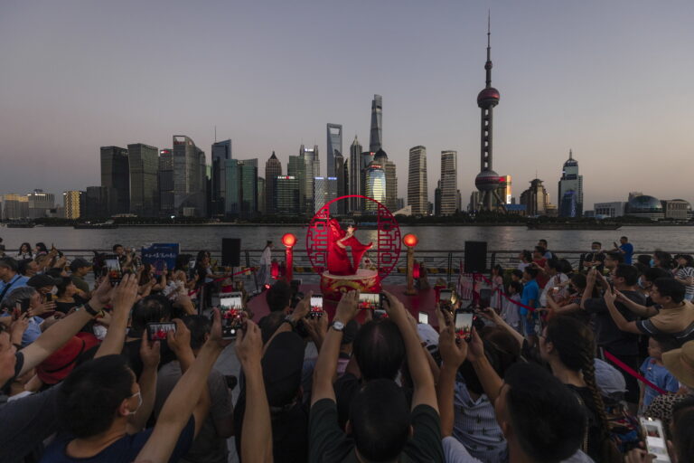 epa09479166 An artist performs along The Bund waterfront area during the Mid-Autumn Festival celebrations in Shanghai, China, 21 September 2021. The Mid-Autumn Festival, also known as Moon Festival, falls this year on 21 September. It is a traditional harvest festival celebrated in many Asian countries and considered one of the most important holidays, after the Chinese Lunar New Year. EPA/ALEX PLAVEVSKI