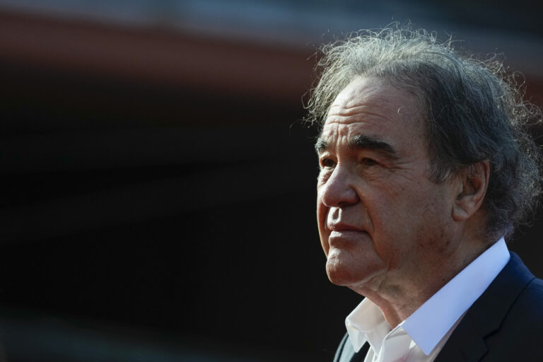 Director Oliver Stone poses on the red carpet for the movie 