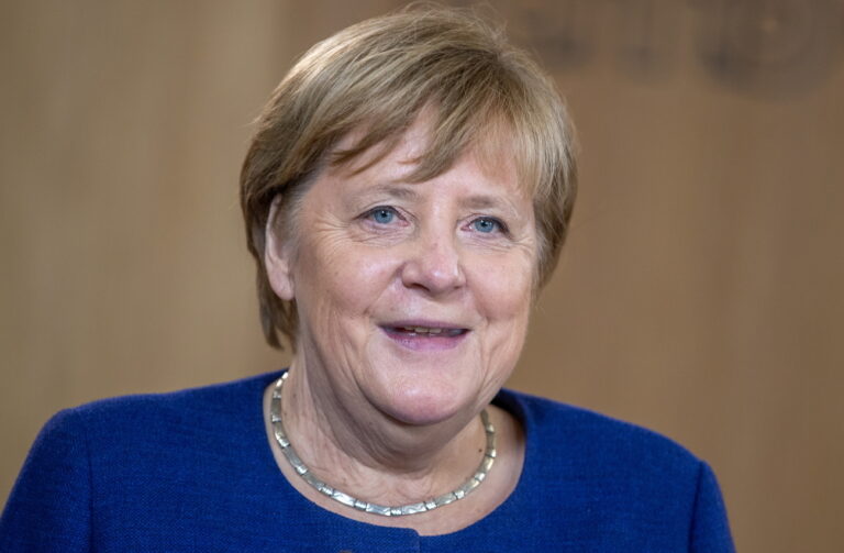 epa09597790 Acting German Chancellor Angela Merkel delivers a speech as she visits the TUMO learning center in Berlin, Germany, 22 November 2021. The center provides digital technologies workshops for youth. EPA/ANDREAS GORA / POOL