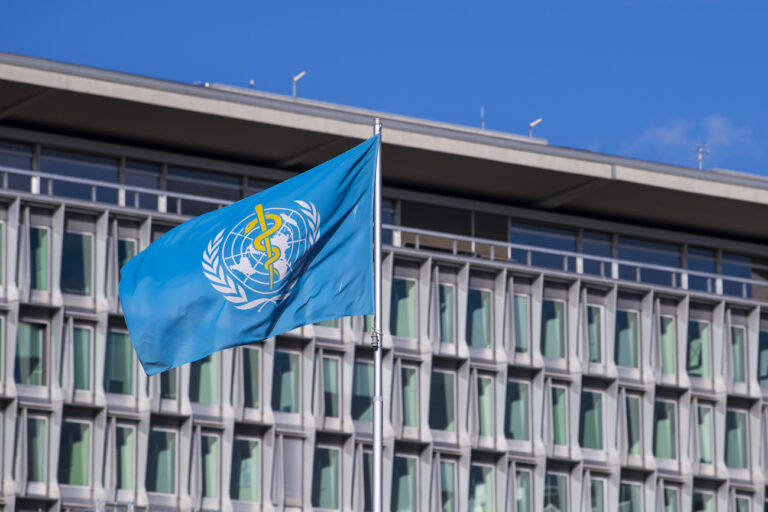 The flag and building of the World Health Organization (WHO) headquarters in Geneva, Switzerland, Wednesday, January 05, 2022. (KEYSTONE/Martial Trezzini) ..