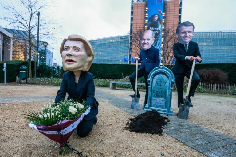 epa09722572 A puppet resembling to European Commission President Ursula von der Leyen surrounded by men wearing masks of German Chancellor Olaf Scholz and French President Emmanuel Macron gather around a pretended Green Deal grave to protest against European Commission decision to label gas and nuclear energy 'sustainable', in Brussels, Belgium, 02 February 2022. Activists are protesting against the EU classification system known as taxonomy after a European Commission proposal to label nuclear energy and natural gas as sustainable under this taxonomy. EPA/STEPHANIE LECOCQ