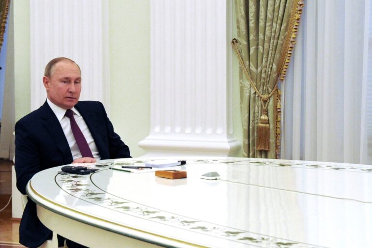 Russian President Vladimir Putin speaks to German Chancellor Olaf Scholz during their talks in the Kremlin in Moscow, Russia, Tuesday, Feb. 15, 2022. (Mikhail Klimentyev, Sputnik, Kremlin Pool Photo via AP)