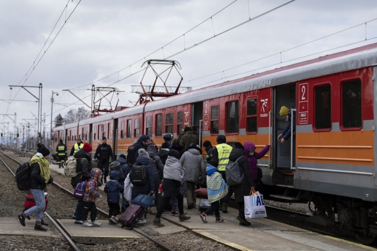Women and children board a train heading to Krakow after fleeing Ukraine, at the border crossing in Medyka, Poland, Thursday, March 10, 2022. U.N. officials said that the Russian onslaught has forced 2 million people to flee Ukraine. (AP Photo/Petros Giannakouris)