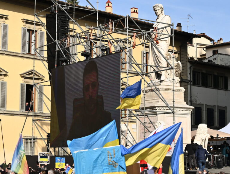 epa09819423 Ukrainian President Volodymyr Zelensky speaks via a video link to the participants of 'Cities Stand With Ukraine' event promoted by European cities belonging to Eurocities to say 'NO to war', in Florence, Italy, 12 March 2022. According to the United Nations refugee agency UNHCR, over 2.5 million people have fled Ukraine since the Russian invasion began on 24 February. Many, however, have decided to stay and fight. EPA/CLAUDIO GIOVANNINI