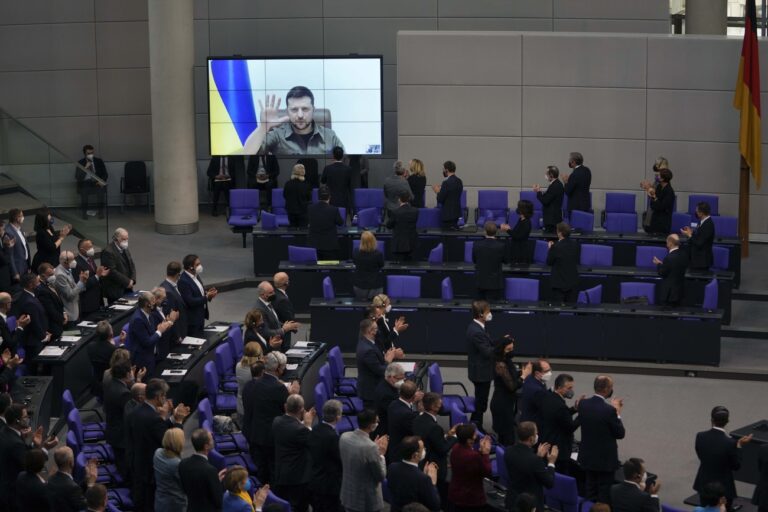 Members of the German parliament Bundestag give Ukraine President Volodymyr Zelensky a standing ovation after he speaks in a virtual address to the parliament at the Reichstag Building in Berlin, Germany, Thursday, March 17, 2022. (AP Photo/Markus Schreiber)