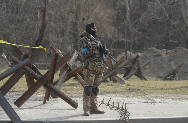 epa09856054 A Ukrainian Territorial Defense fighter stands guard at a roadblock post in Kyiv (Kiev), Ukraine, 28 March 2022 amid the Russian invasion. On 24 February, Russian troops had entered Ukrainian territory in what the Russian president declared a 'special military operation', resulting in fighting and destruction in the country, a huge flow of refugees, and multiple sanctions against Russia. EPA/SERGEY DOLZHENKO