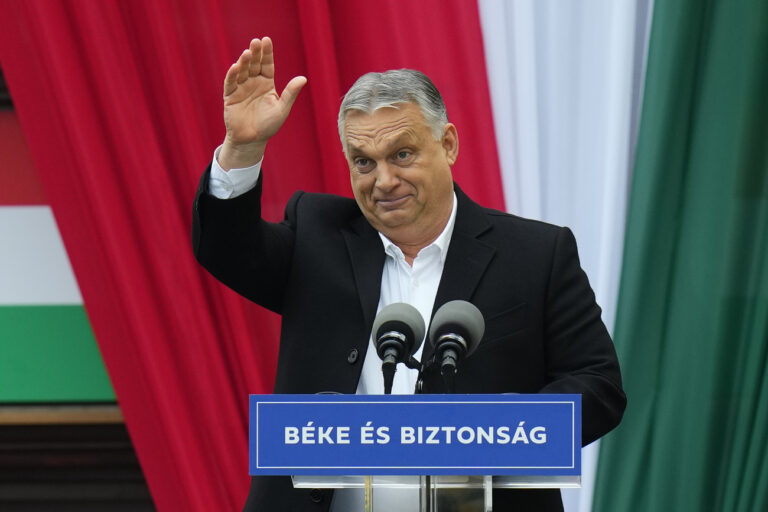 Prime Minister Viktor Orban greets his supporters prior to delivering a speech during the final electoral rally of his Fidesz party ahead of Sunday's election, in Szekesfehervar, Hungary, Friday, April 1, 2022. (AP Photo/Petr David Josek)