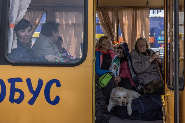 epa09922320 Internally displaced people sit in a bus after arriving from the frontline town of Orikhiv, at the evacuation point in Zaporizhzhia, Ukraine, 02 May 2022. Thousands of people who still remain trapped in Mariupol and other areas occupied by the Russian army in south Ukraine wait to be evacuated to safer areas. EPA/ROMAN PILIPEY
