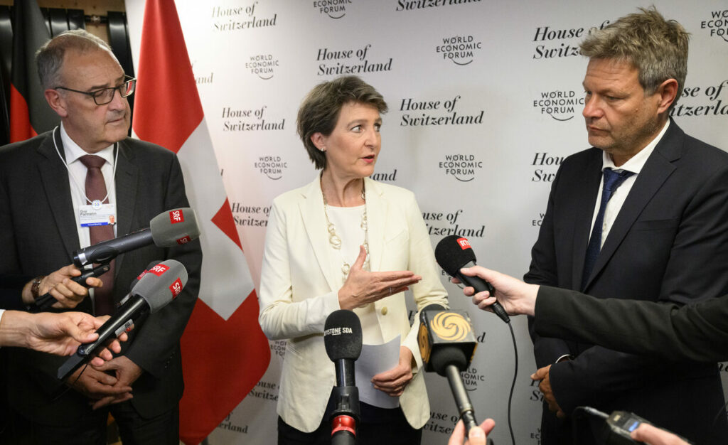 Switzerland's Simonetta Sommaruga, center, Federal councillor for the environment, transport, energy and communications and Switzerland's Guy Parmelin, left, Federal councillor for economic affairs, Education and Germany's Robert Habeck, right, vice-chancellor and Federal minister for economy and climate action speak during a press briefing after a trilateral meeting at the House of Switzerland on the sideline of the 51st annual meeting of the World Economic Forum, WEF, in Davos, Switzerland, on Sunday, May 22, 2022. The forum has been postponed due to the Covid-19 outbreak and was rescheduled to early summer. The meeting brings together entrepreneurs, scientists, corporate and political leaders in Davos under the topic 