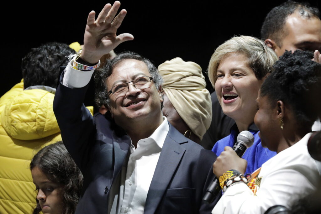 epa10023390 The elected president of Colombia Gustavo Petro (L) waves to supporters while standing next to Francia Marquez (R), elected vice president, after the release of election results, during an event in Bogota, Colombia, 19 June 2022. Colombians elected Gustavo Petro as the new president of the republic for the period 2022 to 2026. EPA/Carlos Ortega