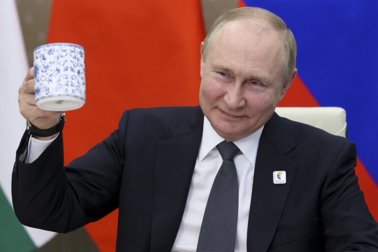 Russian President Vladimir Putin makes a toast as he takes part in a virtual format at the opening ceremony of the BRICS Business Forum via videoconference in Moscow region, in Moscow, Russia, Thursday, June 23, 2022. (Mikhail Metzel/Sputnik, Kremlin Pool Photo via AP)