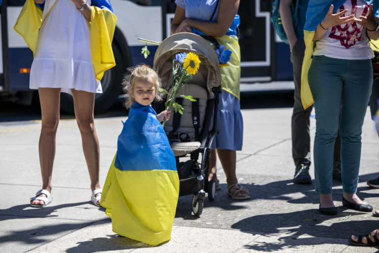 Protestors carry placards during a demonstration against the Russian invasion of Ukraine in front of the Palais des Nations during a Russian demonstration against the war in Ukraine in Geneva, Switzerland, on Saturday, 02 July 2022. (KEYSTONE/Martial Trezzini)