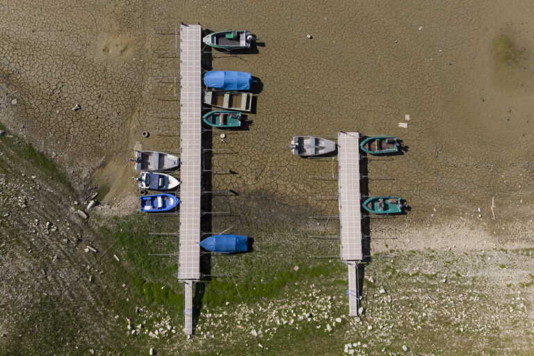 Stranded boats are pictured on the dried out shore of the Brenet Lake (French: Lac des Brenets) part of the Doubs river, a natural border beetwen eastern France and western Switzerland, Monday, July 18, 2022. (KEYSTONE/Anthony Anex)