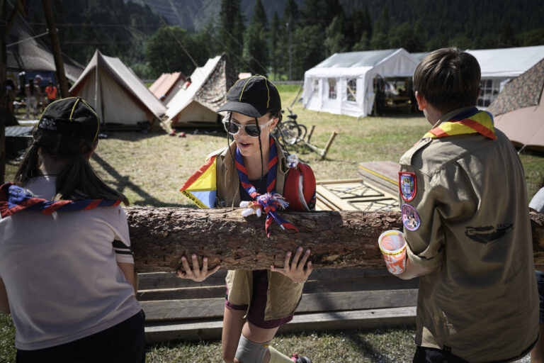 Scouts carry a tree trunk to their camp of the second day of the Federal Scout Camp, mova, this Sunday, July 24, 2022 in the Goms Valley in Ulrichen. The biggest scout camp ever will take place in the Goms Valley from July 23 to August 6, 2022. This unique event, which takes place every 14 years, gathers about 30'000 scouts from all over Switzerland during two weeks. (KEYSTONE/Gabriel Monnet)
