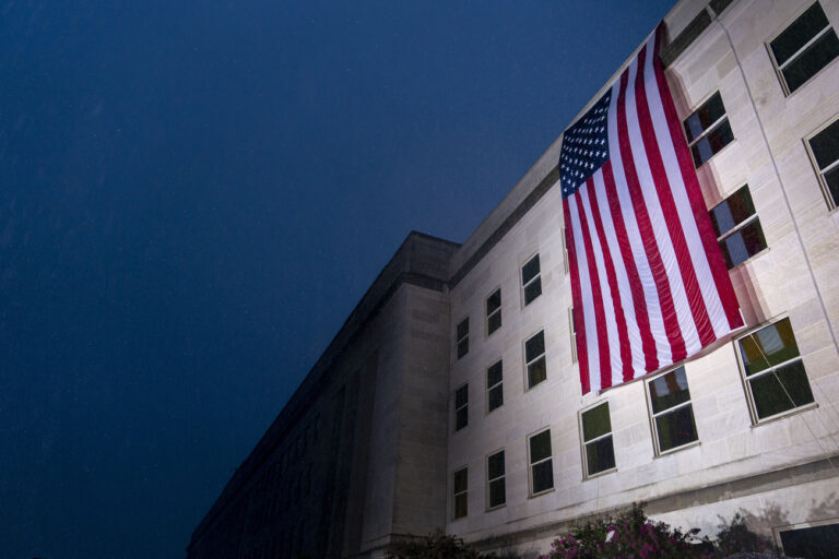 A U.S. flag is unfurled at the Pentagon in Washington, Sunday, Sept. 11, 2022, at sunrise on the morning of the 21st anniversary of the 9/11 terrorist attacks. (AP Photo/Andrew Harnik)