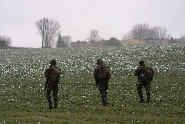 Polish soldiers search for missile wreckage in the field, near the place where a missile struck, in a farmland at the Polish village of Przewodow, near the border with Ukraine, Thursday, Nov. 17, 2022. (AP Photo/Vasilisa Stepanenko)