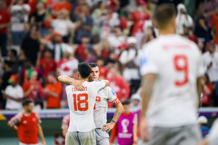 Switzerland's defender Eray Coemert and Switzerland's midfielder Granit Xhaka react after the elimination during the FIFA World Cup Qatar 2022 round of 16 soccer match between Portugal and Switzerland at the Lusail Stadium in Lusail, north of Doha, Qatar, Tuesday, December 6, 2022. (KEYSTONE/Laurent Gillieron)