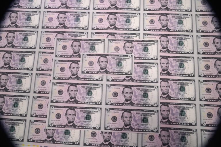 Five dollar bills are displayed during a visit to the Bureau of Engraving and Printing's (BEP) Western Currency Facility in Fort Worth, Texas, Thursday, Dec. 8, 2022. (AP Photo/LM Otero)