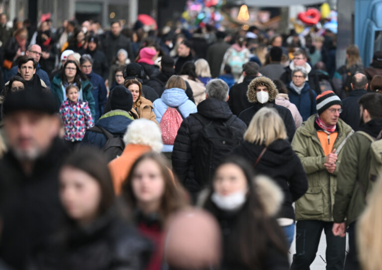 28.12.2022, Hessen, Frankfurt/Main: Ein Mann, der Maske trägt, geht in der Menschenmenge über die Frankfurter Einkaufsmeile Zeil. Foto: Arne Dedert/dpa +++ dpa-Bildfunk +++ (KEYSTONE/DPA/Arne Dedert)