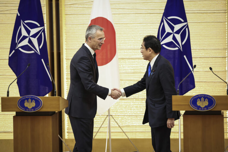 NATO Secretary-General Jens Stoltenberg, left, and Japan's Prime Minister Fumio Kishida shake hands after holding a joint media briefing on Tuesday, Jan. 31, 2023, in Tokyo. (Takashi Aoyama/Pool Photo via AP)