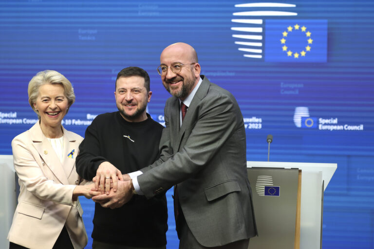 From left, European Commission President Ursula von der Leyen, Ukraine's President Volodymyr Zelenskyy, center, and European Council President Charles Michel join hands after addressing a media conference at an EU summit in Brussels on Thursday, Feb. 9, 2023. European Union leaders are meeting for an EU summit to discuss Ukraine and migration. (AP Photo/Olivier Matthys)